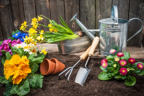 Gardener with tools at a Norbiton garden entrance